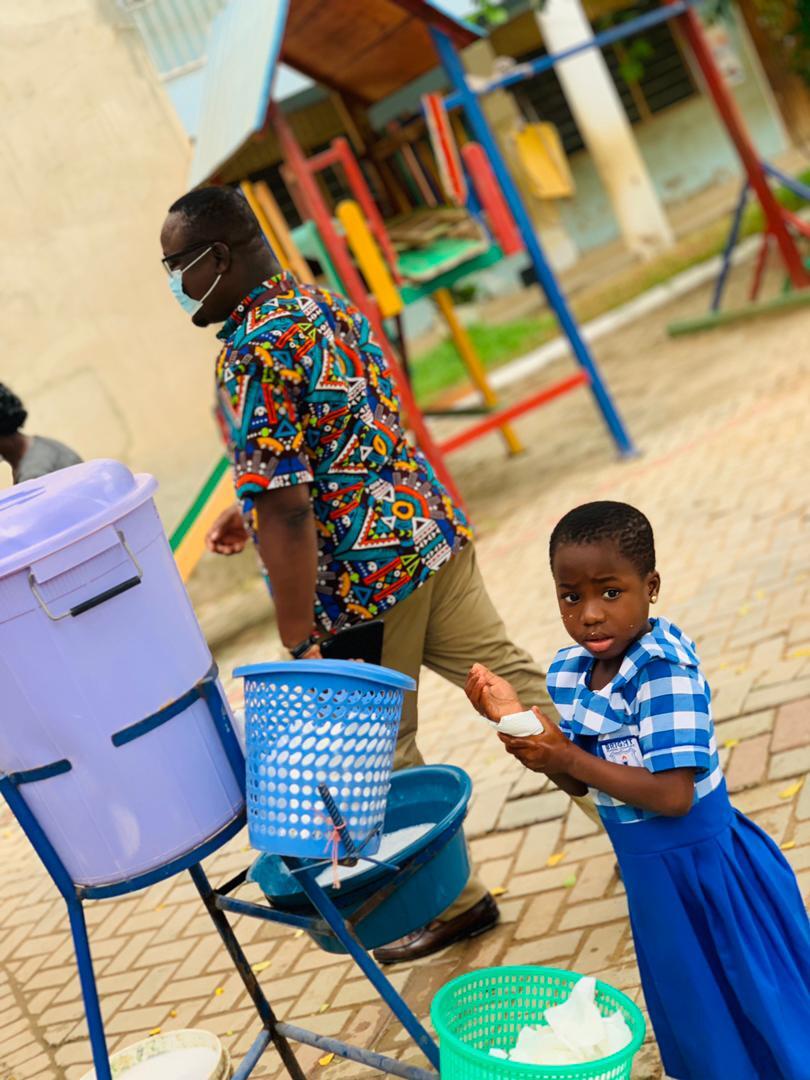 Girl student washing hands at Ghanaian primary school